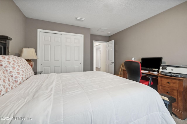 bedroom with a closet, visible vents, and a textured ceiling