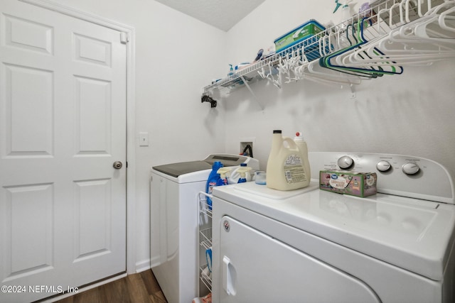 washroom featuring laundry area, dark wood-style flooring, and washing machine and dryer