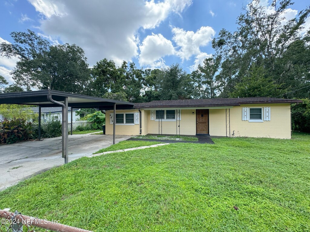 single story home with a carport and a front yard