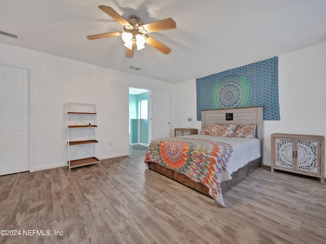 bedroom with ceiling fan and wood-type flooring