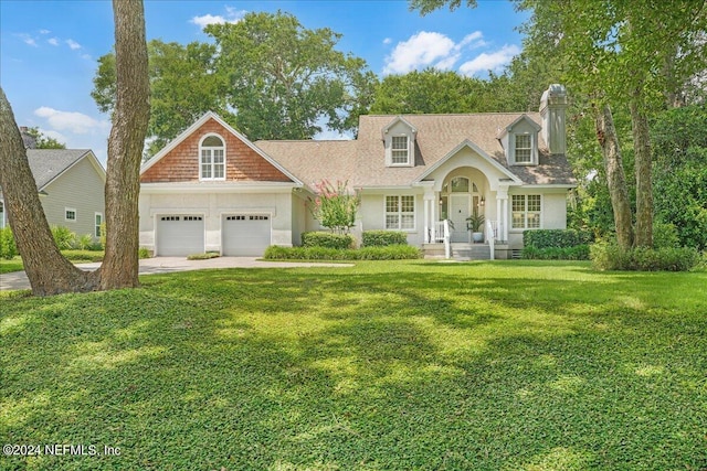 cape cod home with a garage and a front yard