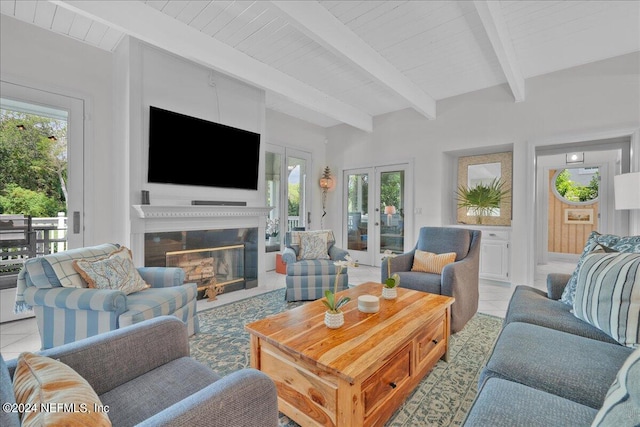 living room featuring light tile patterned floors, a healthy amount of sunlight, beamed ceiling, and french doors