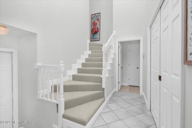 staircase with tile patterned floors