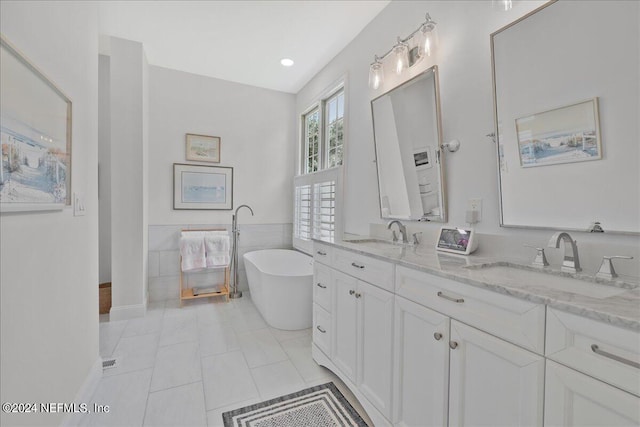 bathroom featuring a tub, tile walls, vanity, and tile patterned floors