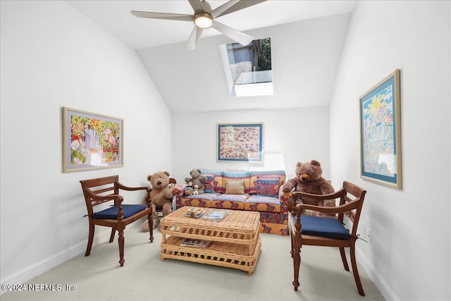 living room with lofted ceiling, ceiling fan, and carpet floors