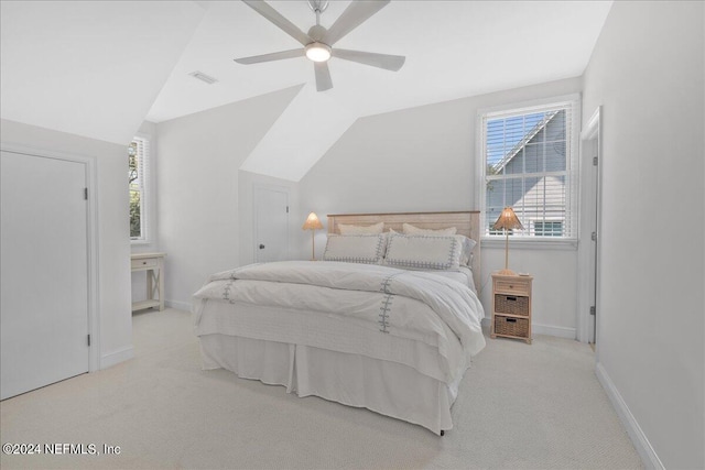 carpeted bedroom with vaulted ceiling and ceiling fan