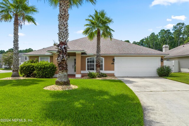 ranch-style home featuring a garage and a front lawn