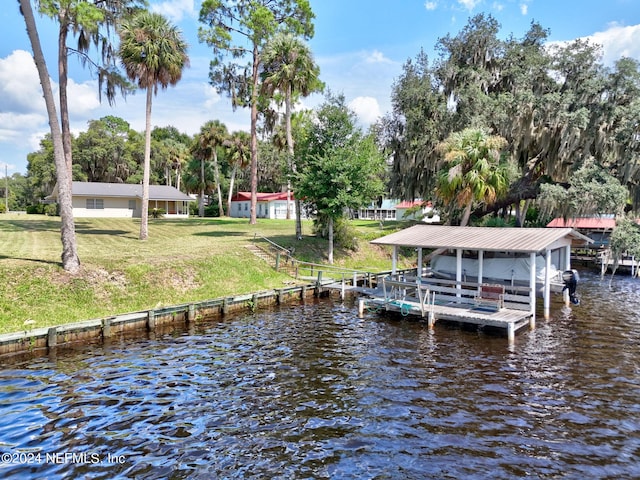 dock area featuring a lawn and a water view