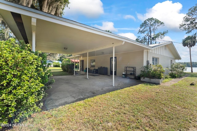 exterior space with a carport and a yard