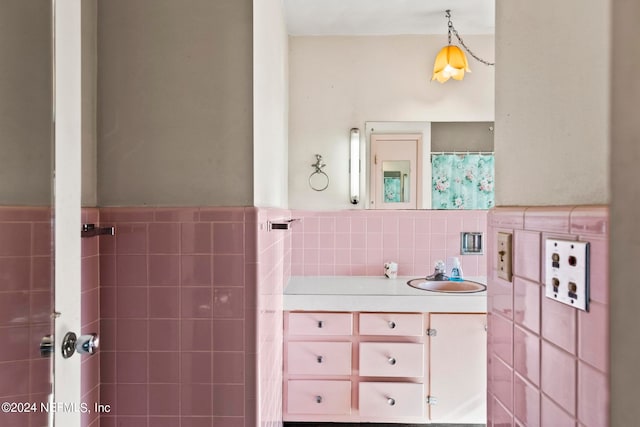 bathroom with tile walls, vanity, and tasteful backsplash