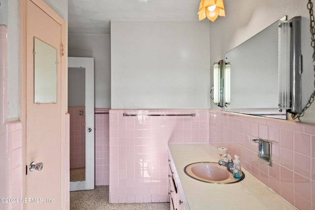 bathroom with decorative backsplash, vanity, and tile walls