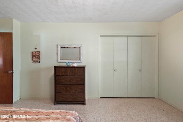 carpeted bedroom with a closet