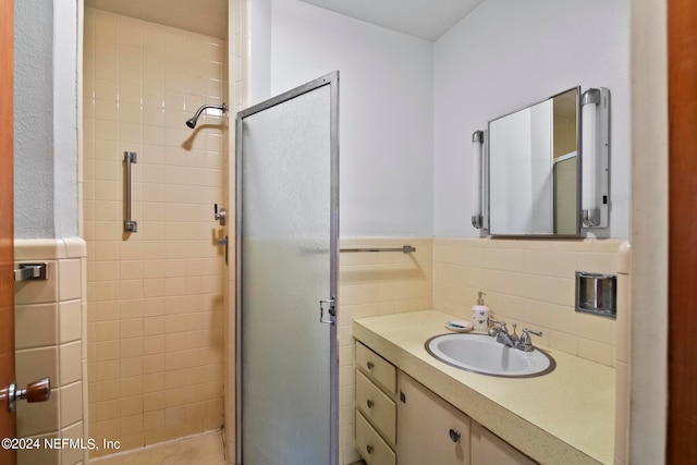 bathroom featuring backsplash, a shower with door, and vanity