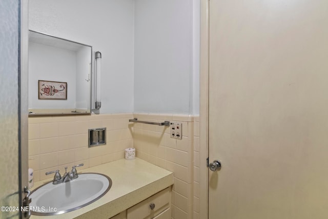 bathroom with tile walls, decorative backsplash, and vanity