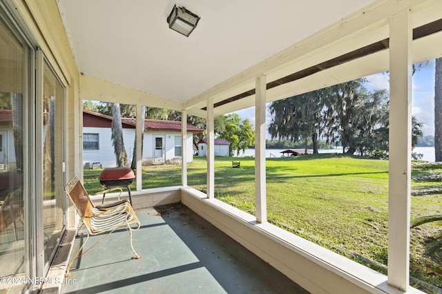 sunroom / solarium featuring a water view