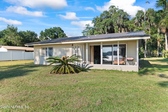 back of house with a lawn