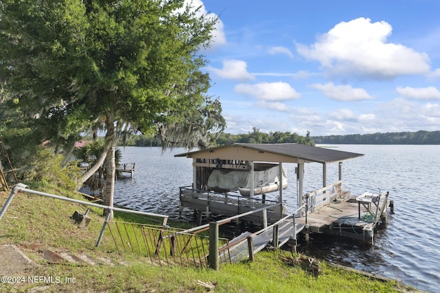 dock area with a water view and boat lift