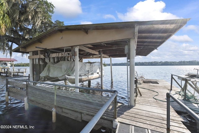 view of dock with a water view and boat lift