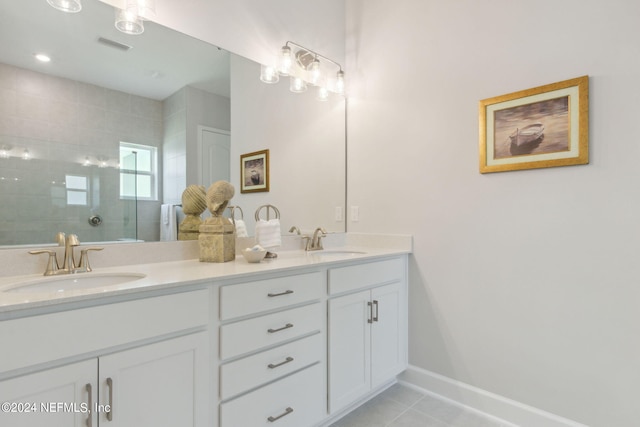 bathroom featuring tile patterned floors, vanity, and a shower with shower door