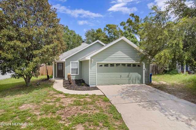 single story home with a garage and a front lawn