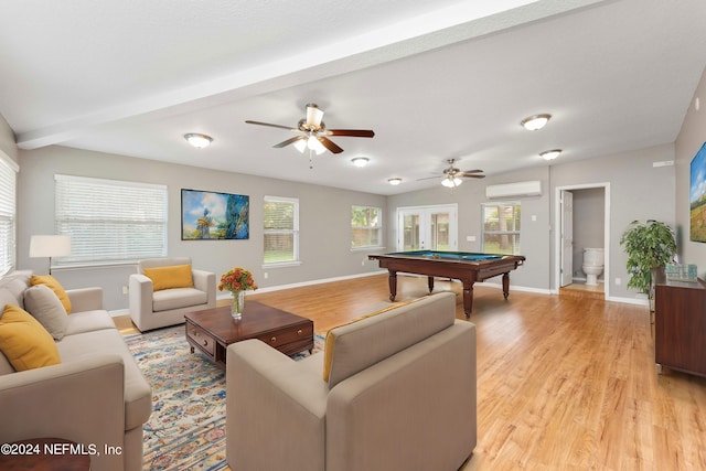 interior space featuring a wall mounted AC, a wealth of natural light, pool table, and light hardwood / wood-style floors