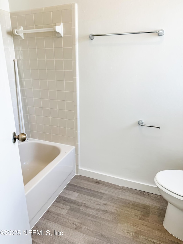 bathroom with toilet and hardwood / wood-style floors