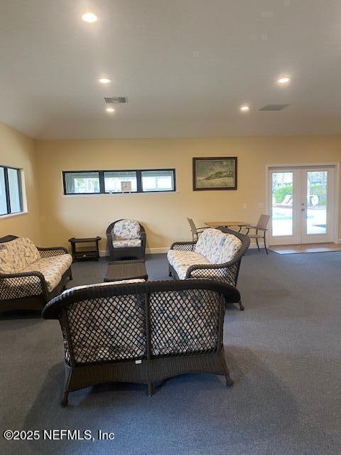 living room featuring carpet flooring and french doors