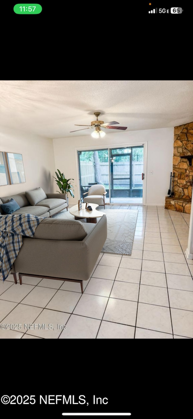 living area featuring tile patterned flooring and a ceiling fan