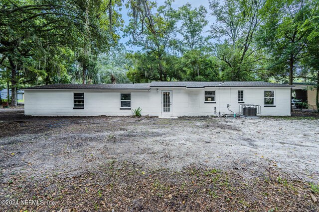 rear view of house featuring central AC