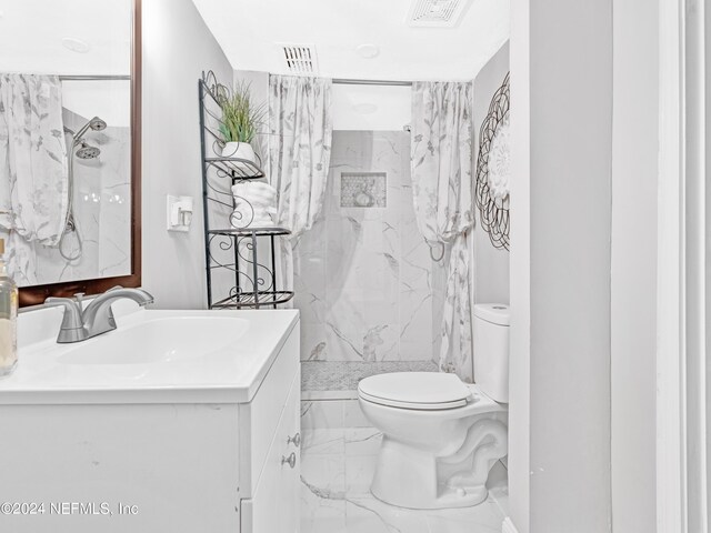 bathroom featuring tile patterned flooring, toilet, vanity, and tiled shower