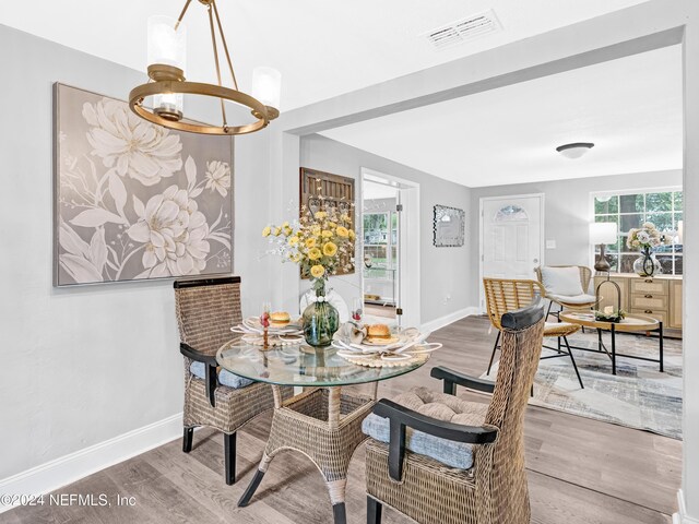 dining area featuring an inviting chandelier and wood-type flooring