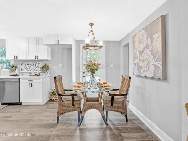 dining area featuring a notable chandelier and light hardwood / wood-style flooring