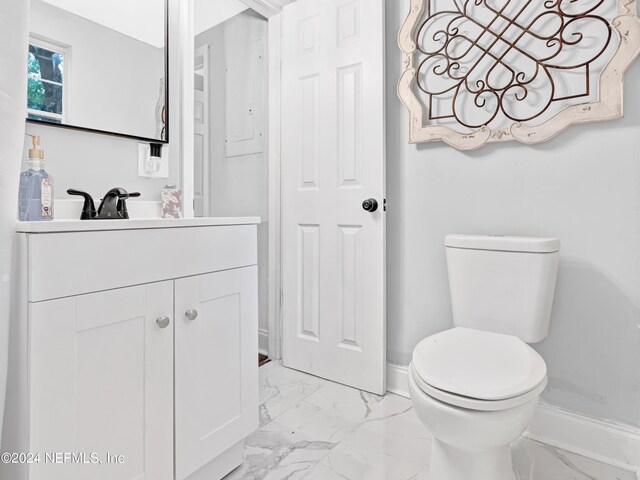 bathroom with tile patterned flooring, vanity, and toilet