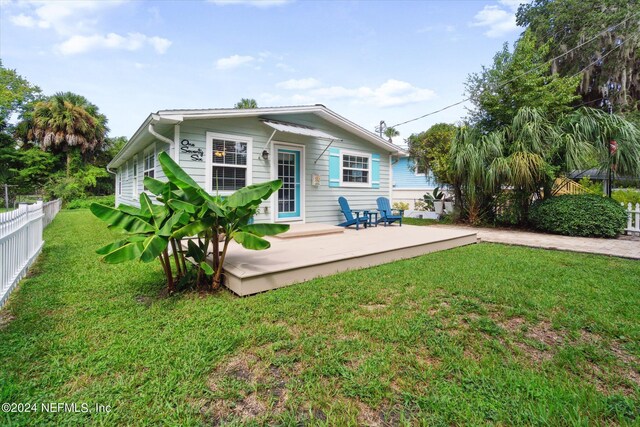 rear view of property with a yard and a patio