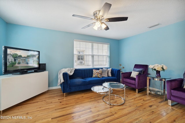 living room featuring light hardwood / wood-style flooring and ceiling fan