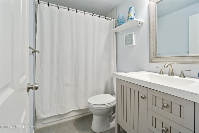 full bath featuring shower / bath combination with curtain, vanity, toilet, and a textured ceiling