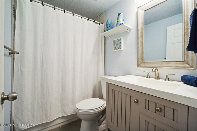 full bathroom with toilet, tile patterned floors, vanity, a textured ceiling, and independent shower and bath