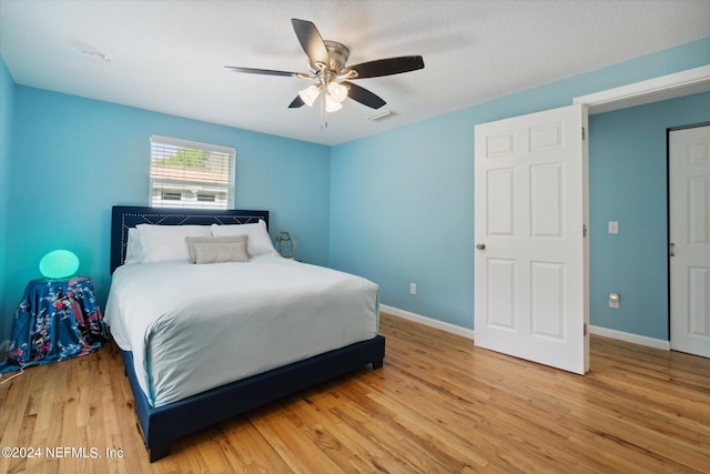 bedroom featuring light hardwood / wood-style flooring and ceiling fan