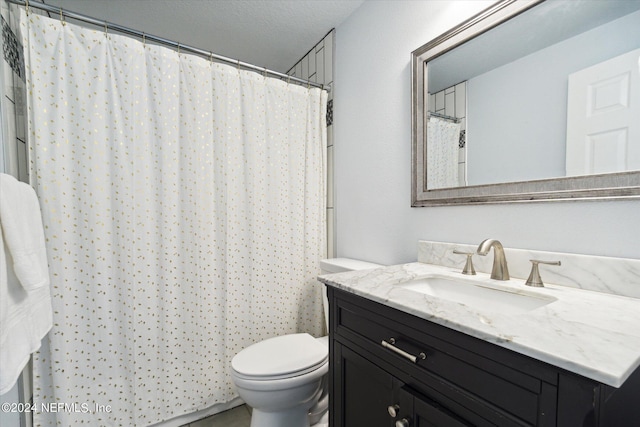 bathroom featuring vanity, toilet, curtained shower, and a textured ceiling