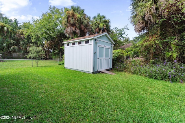 view of outbuilding featuring a yard