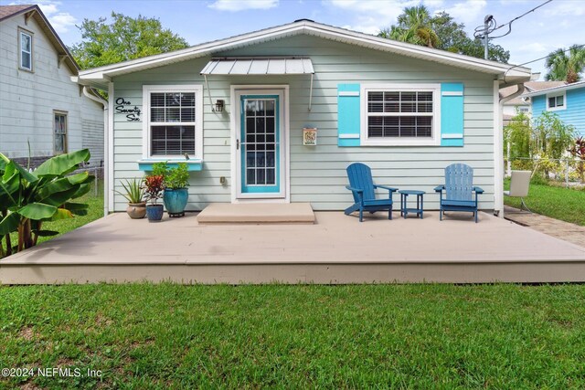 rear view of house with a yard