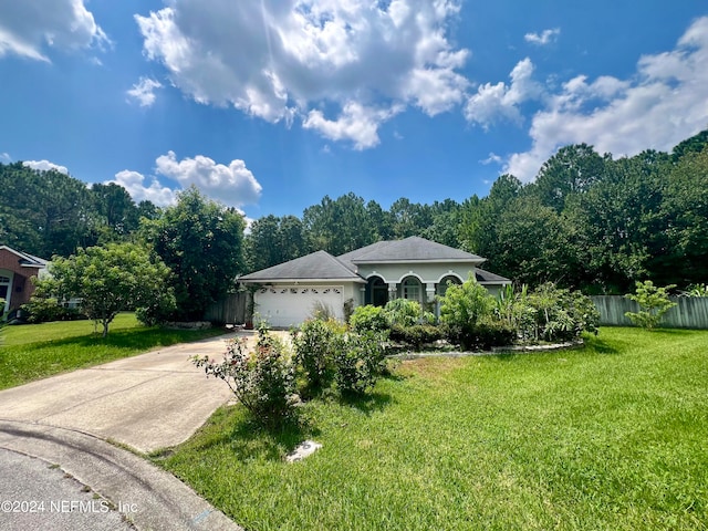 view of front of property featuring a garage and a front lawn