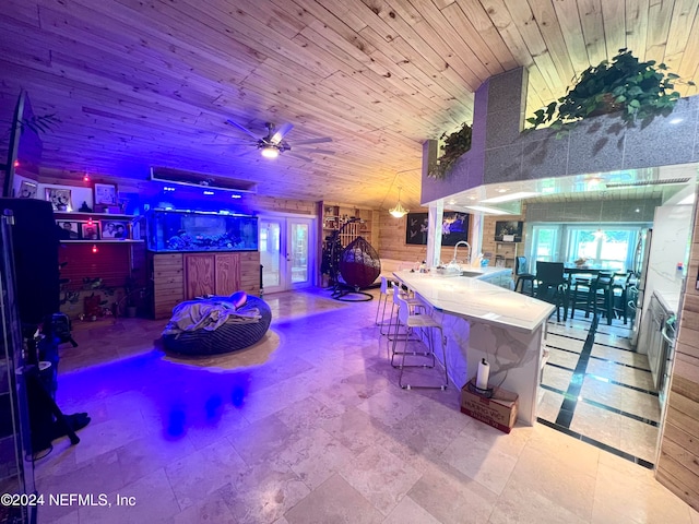 interior space featuring sink, wooden ceiling, light tile patterned flooring, and multiple windows