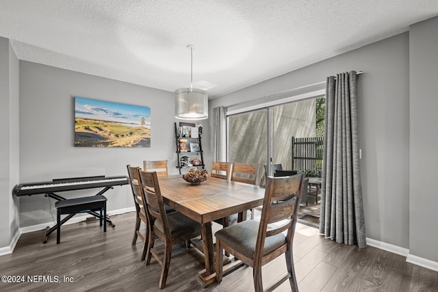 dining space featuring dark hardwood / wood-style floors and a textured ceiling