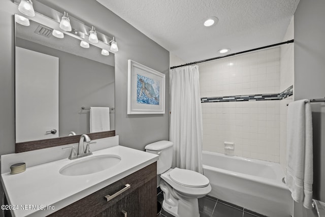 full bathroom with toilet, tile patterned floors, vanity, a textured ceiling, and shower / bath combo with shower curtain