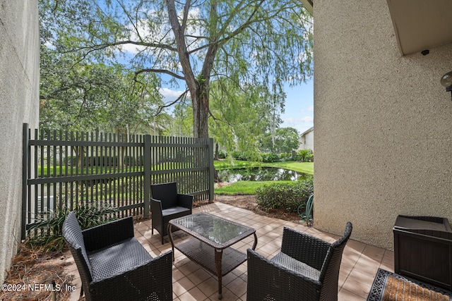 view of patio featuring a water view and an outdoor living space