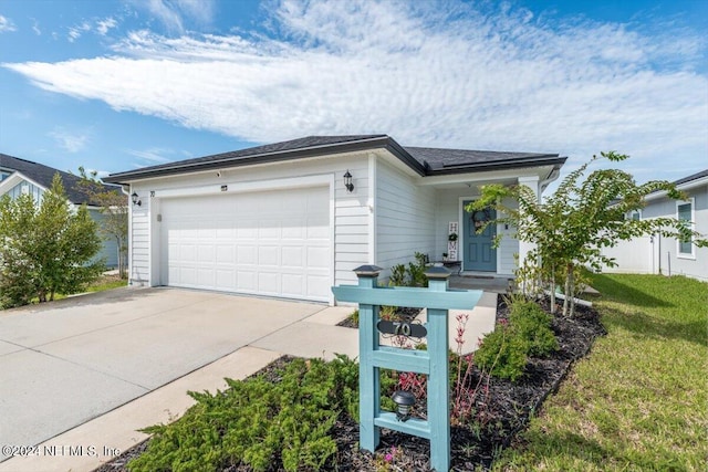 single story home with a front yard and a garage