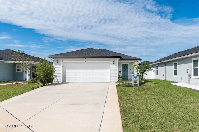 ranch-style house featuring a front yard and a garage