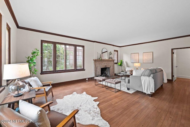 living room featuring crown molding, a brick fireplace, and hardwood / wood-style flooring