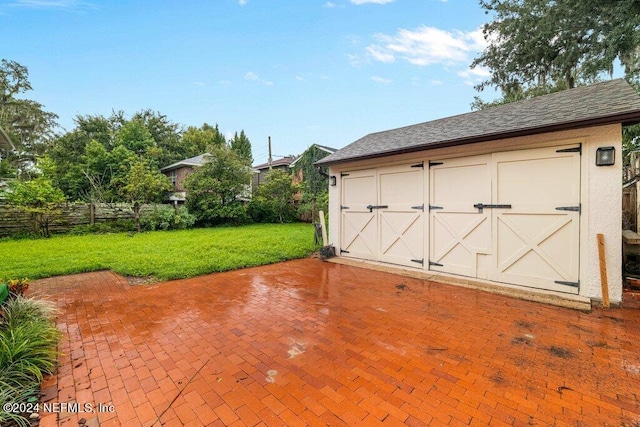 garage featuring a lawn